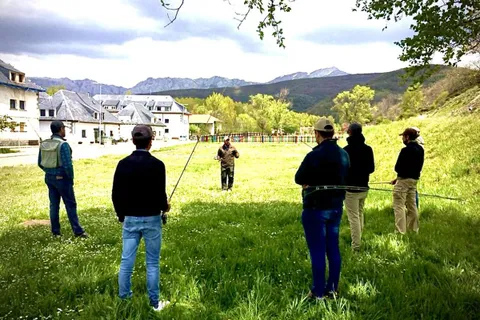 A casting clinic in a meadow below the Cantabrian mountains