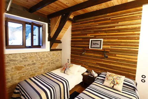 A double bedroom with timber-lined walls